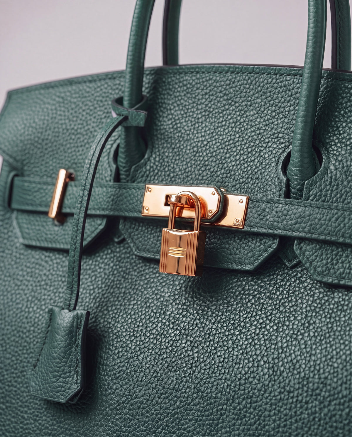 Lock Small leather top-handle bag in Velvet Green – close-up of the gold turn-lock and padlock