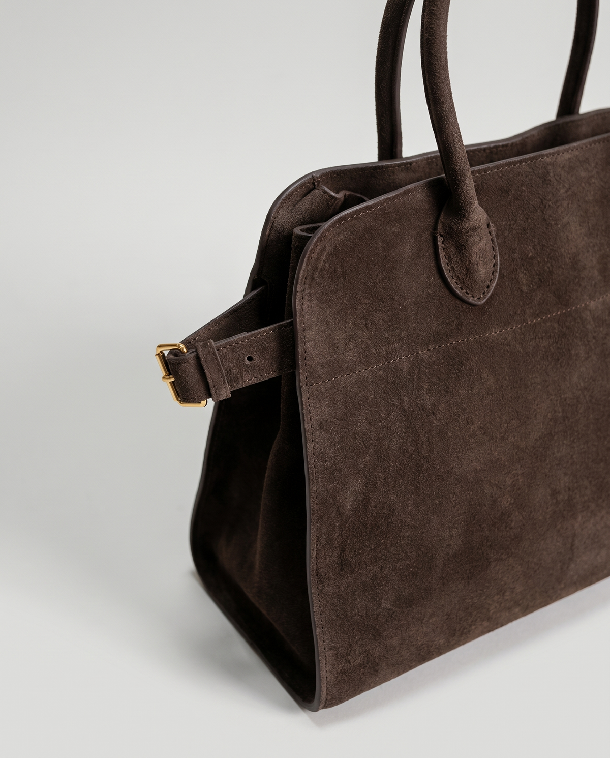 Milano Small top-handle bag in Chocolate suede – close-up of the handle and gold side buckle