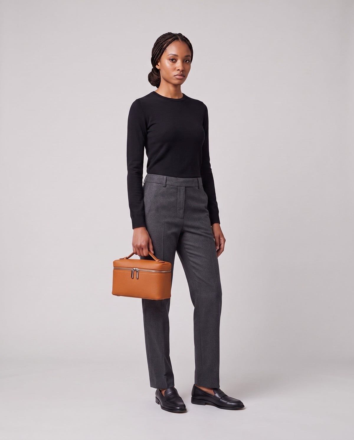 Model holding the Valentina Orvieto Small top-handle bag in Cognac leather, full length