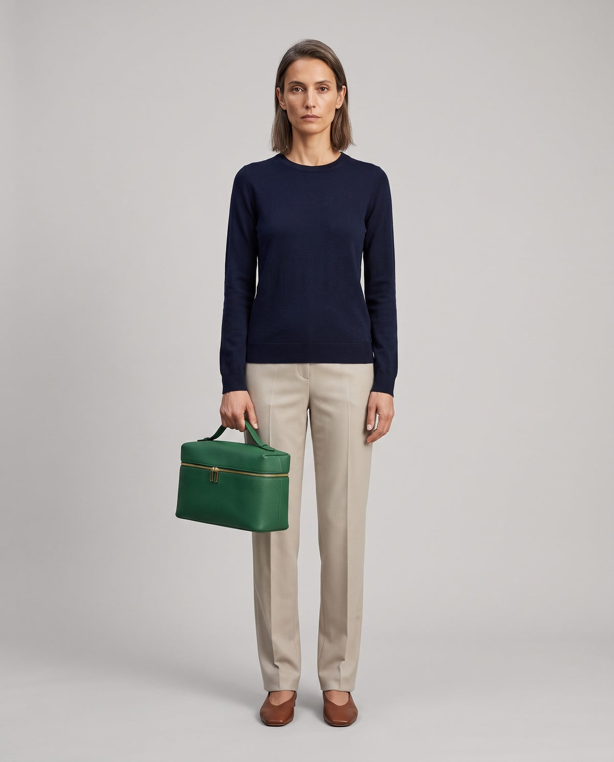 Model holding the Orvieto vanity case in Green – full-length view