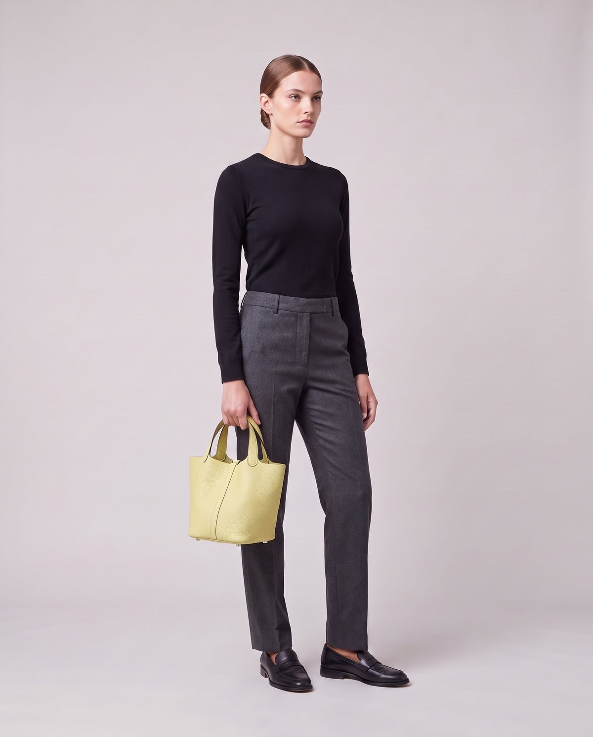Model holding the Valentina Ostuni Large bag in Butter, full length