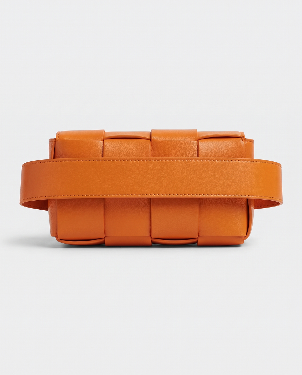 Cassette padded woven leather belt bag in Orange – back view showing the belt strap