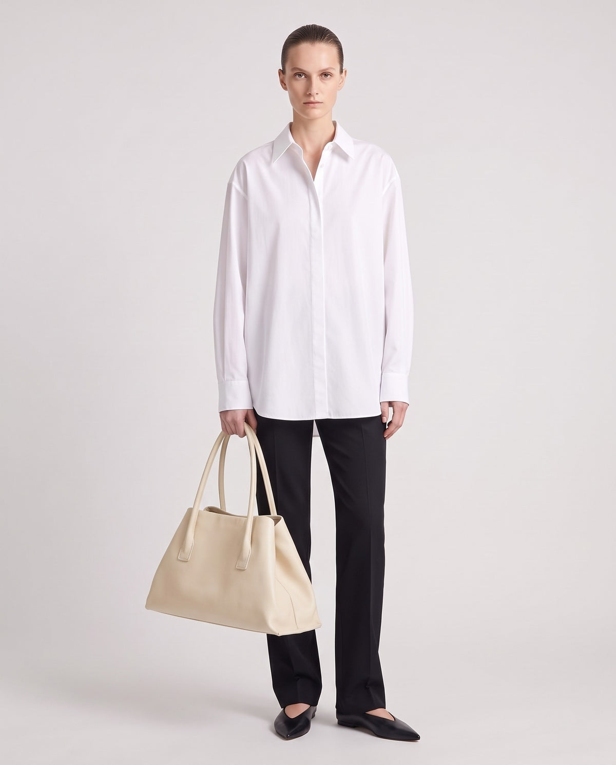 Piano leather tote in Ivory – model holding it, full length