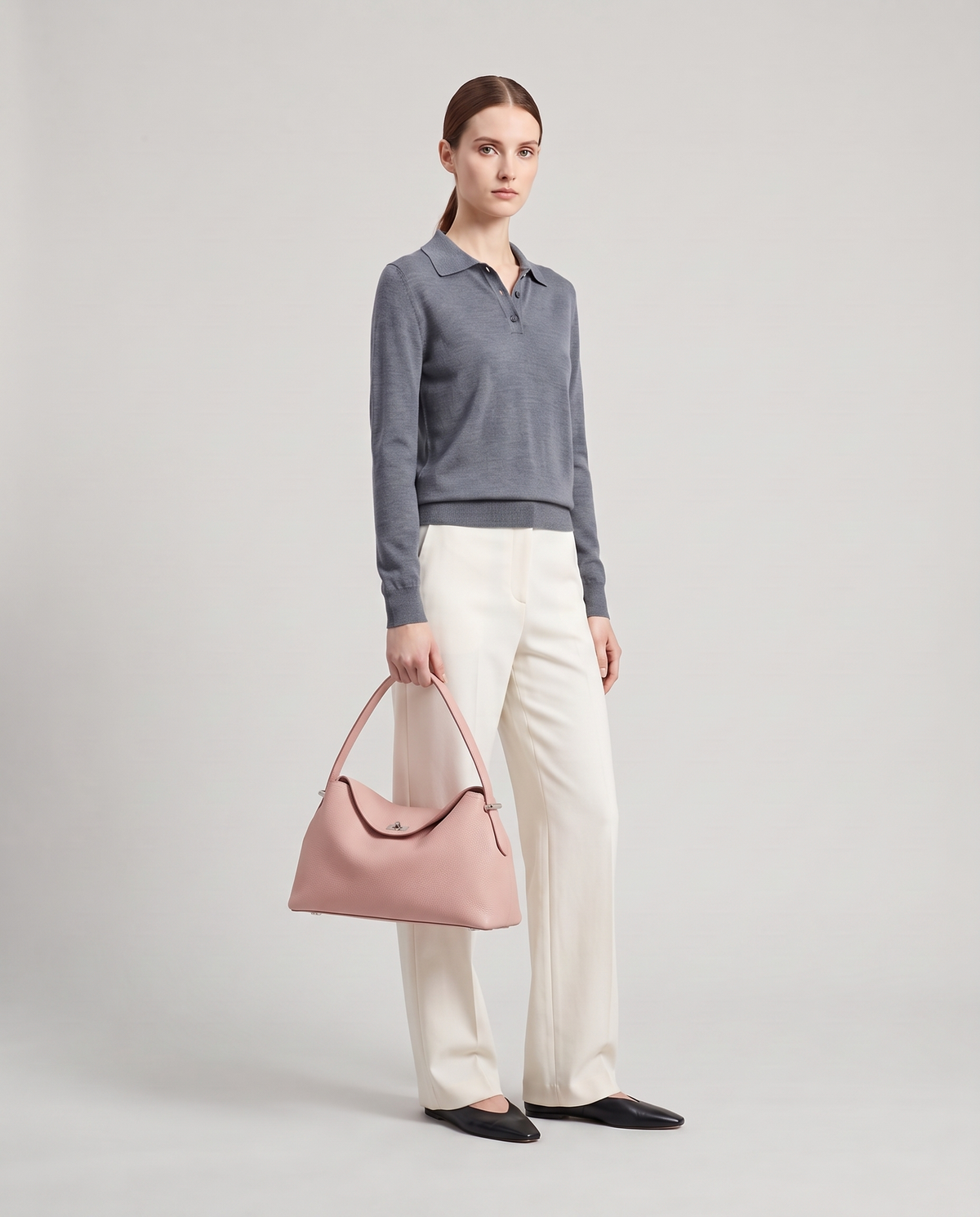 Model with the Porto pebbled leather top-handle bag in blush, full length