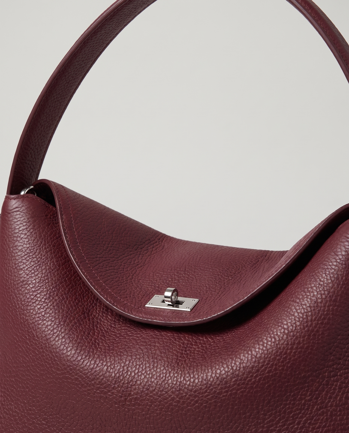 Porto pebbled leather top-handle bag in burgundy, hardware and leather detail