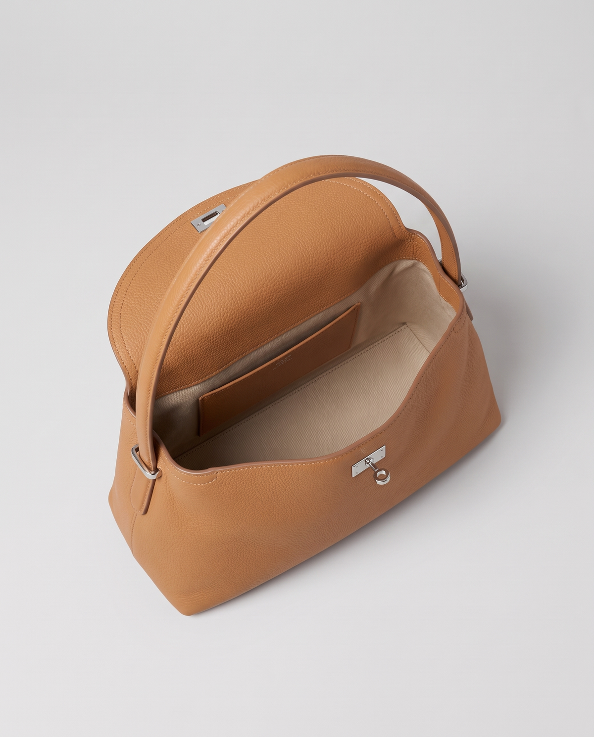 Porto pebbled leather top-handle bag in camel, open showing interior