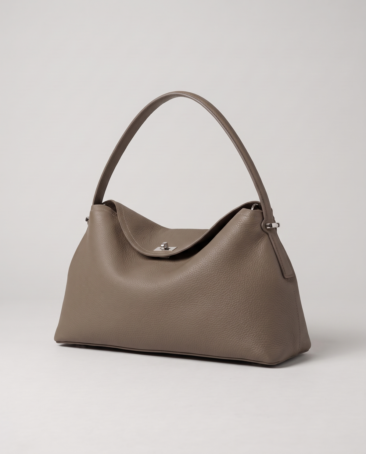 Porto pebbled leather top-handle bag in taupe, three-quarter view