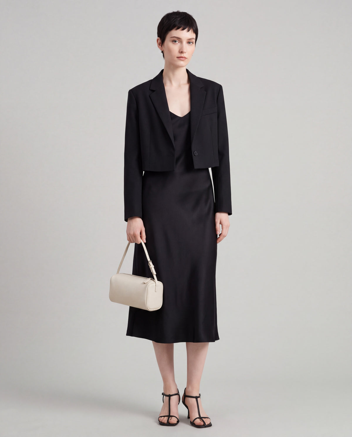 Roll bag in Ivory – worn by model, full length