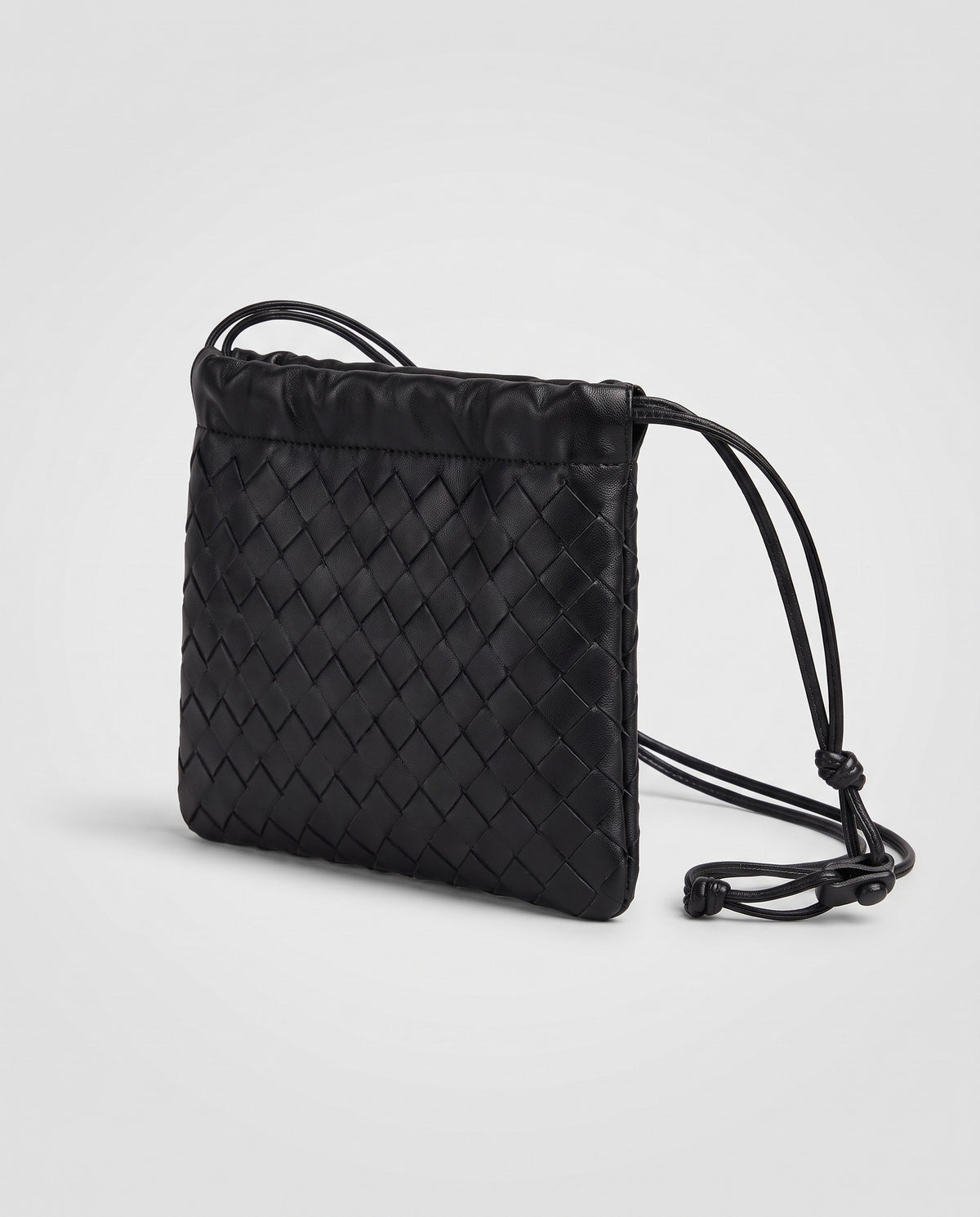 Serata woven leather clutch in black – three-quarter view