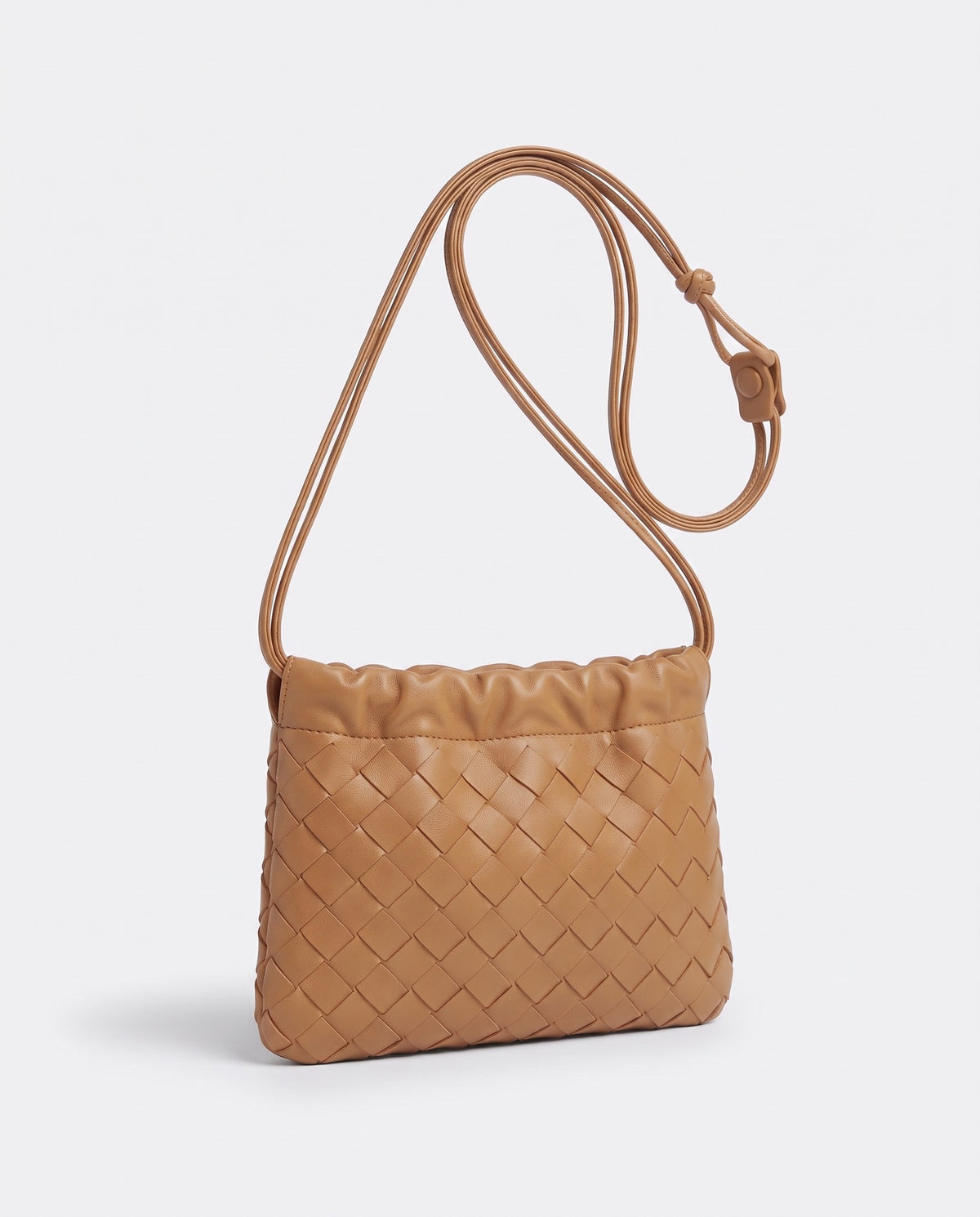 Serata woven leather clutch in Camel – three-quarter view