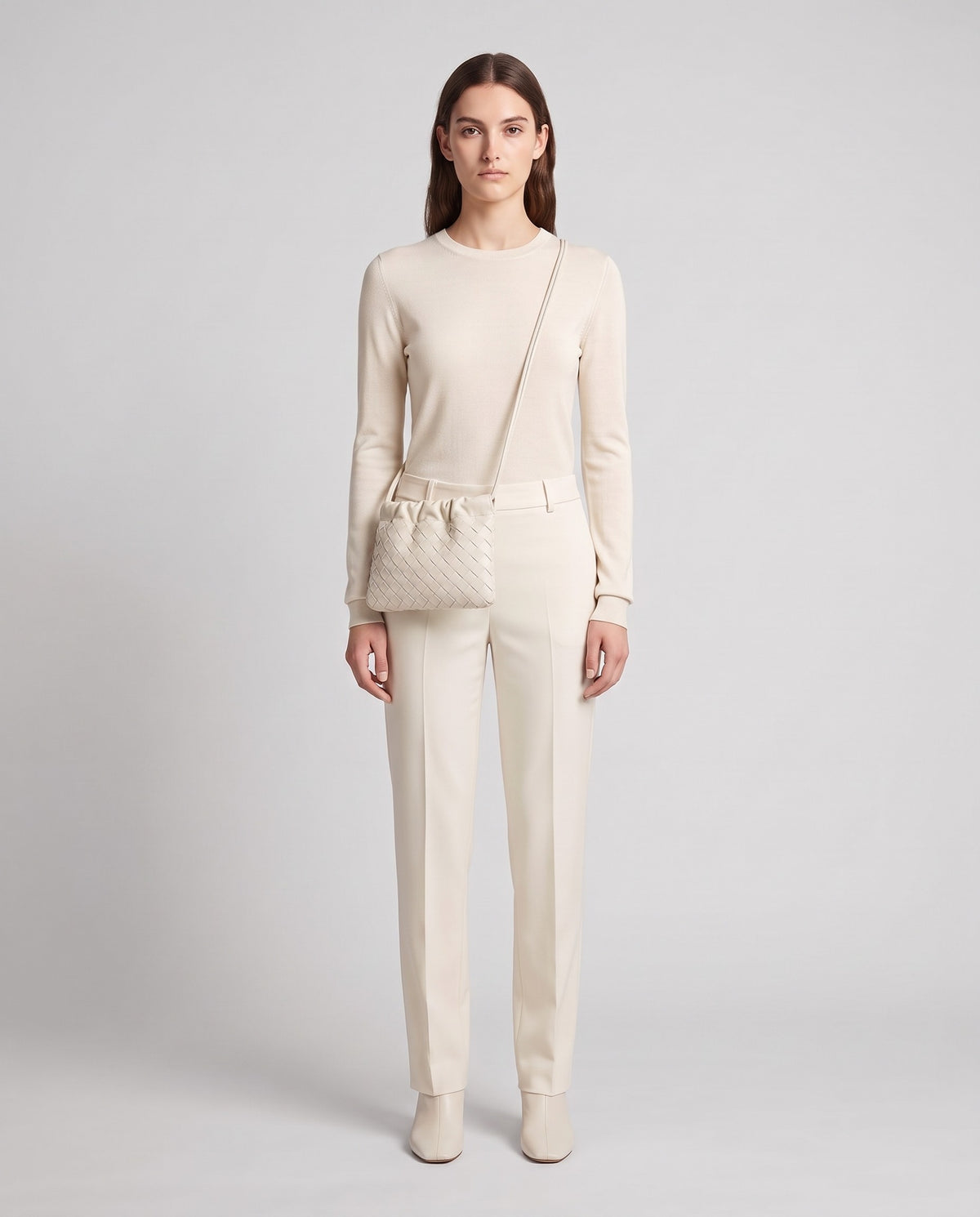 Model wearing the Serata woven leather clutch in Ivory – full length