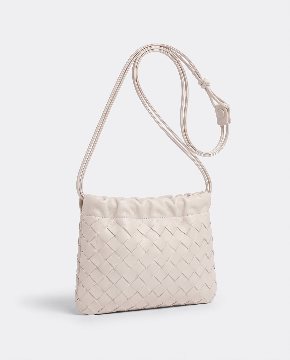 Serata woven leather clutch in Ivory – three-quarter view