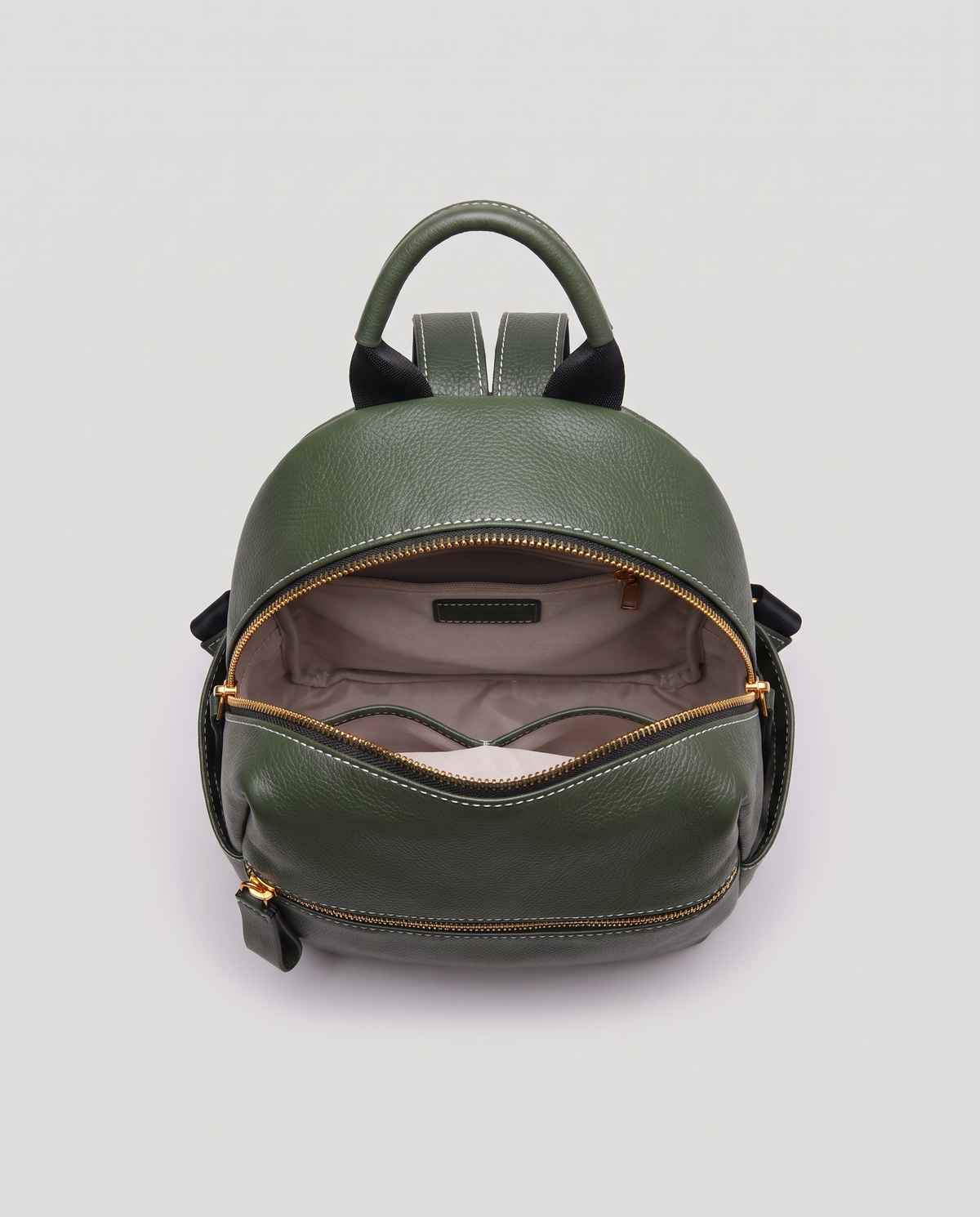 Tab pebbled leather backpack in Forest – main compartment open, showing the lined interior