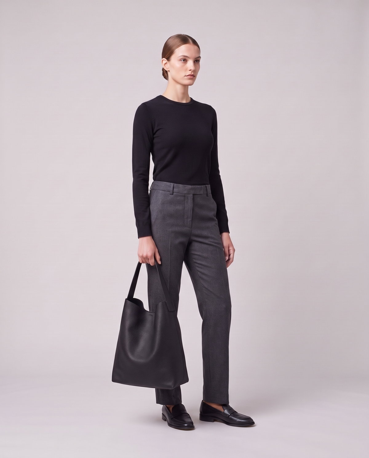 Model holding the Valentina Tela Small bag in Black, full length