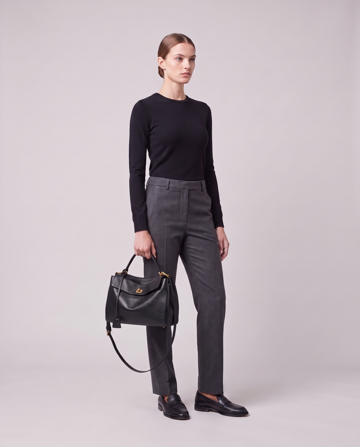 Model holding the Valentina Tinto Small bag in Black, full length