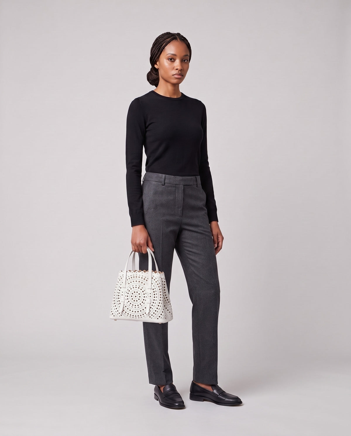 Model holding the Valentina Urbino Medium bag in White, full length