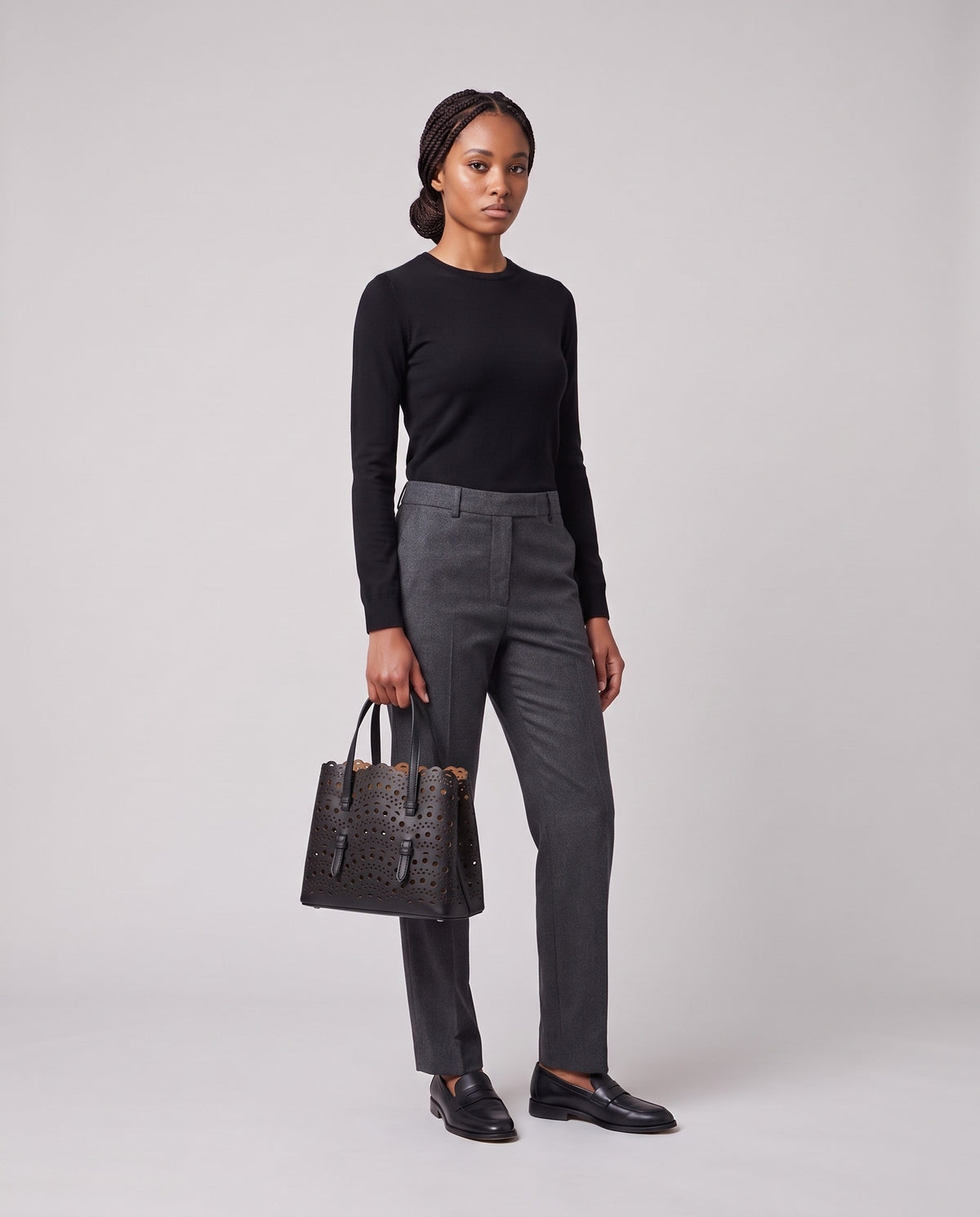 Model holding the Valentina Urbino Small bag in Black, full length