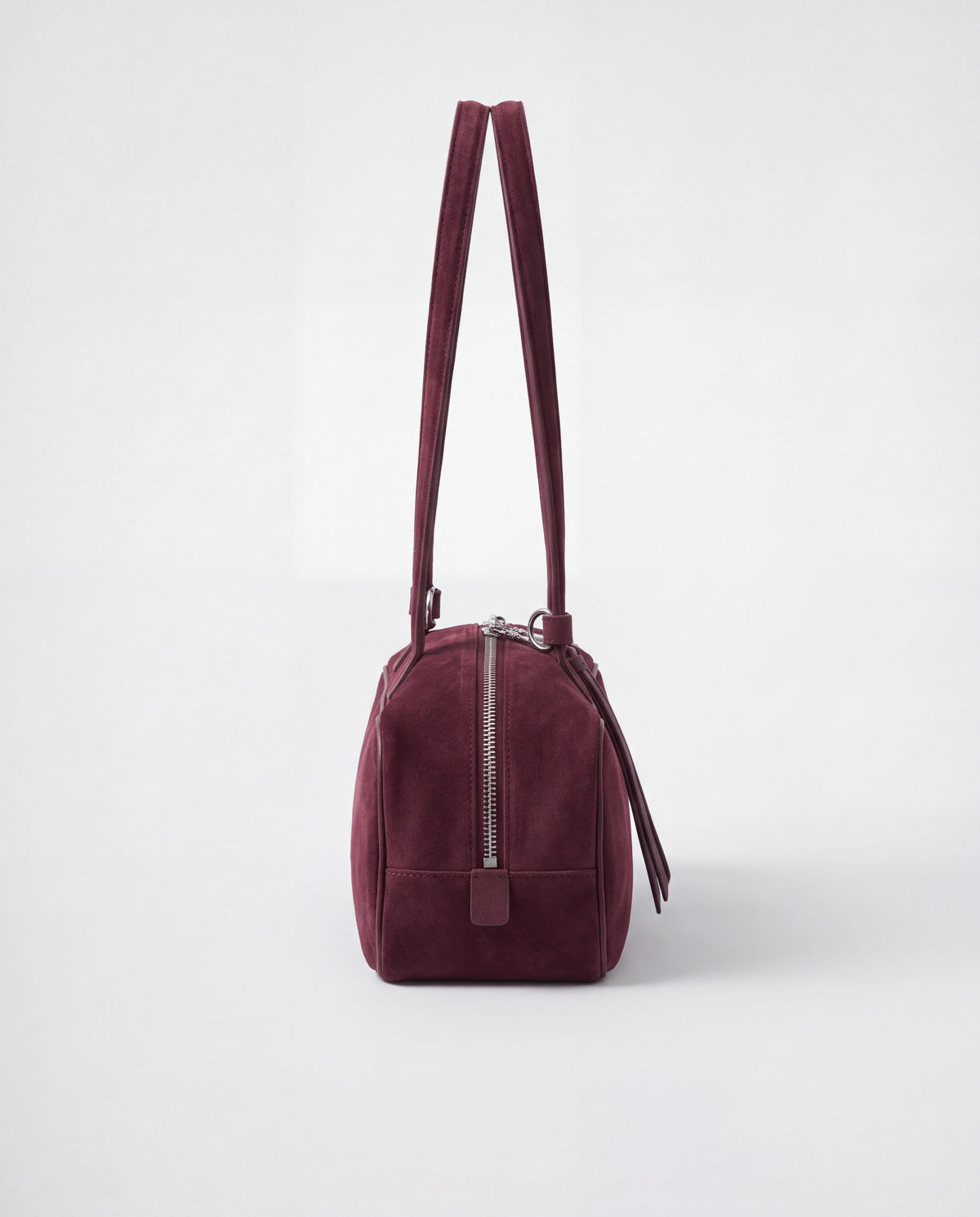 Valentina Linea suede shoulder bag in Burgundy, side view showing the end zip