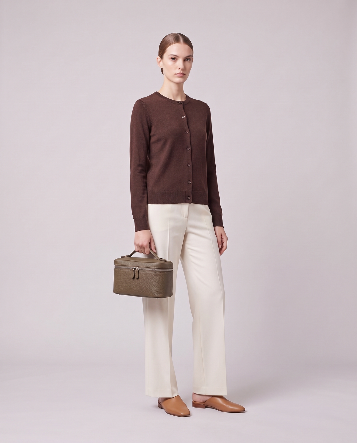 Model holding the Valentina Orvieto Small top-handle bag in Taupe leather, full length