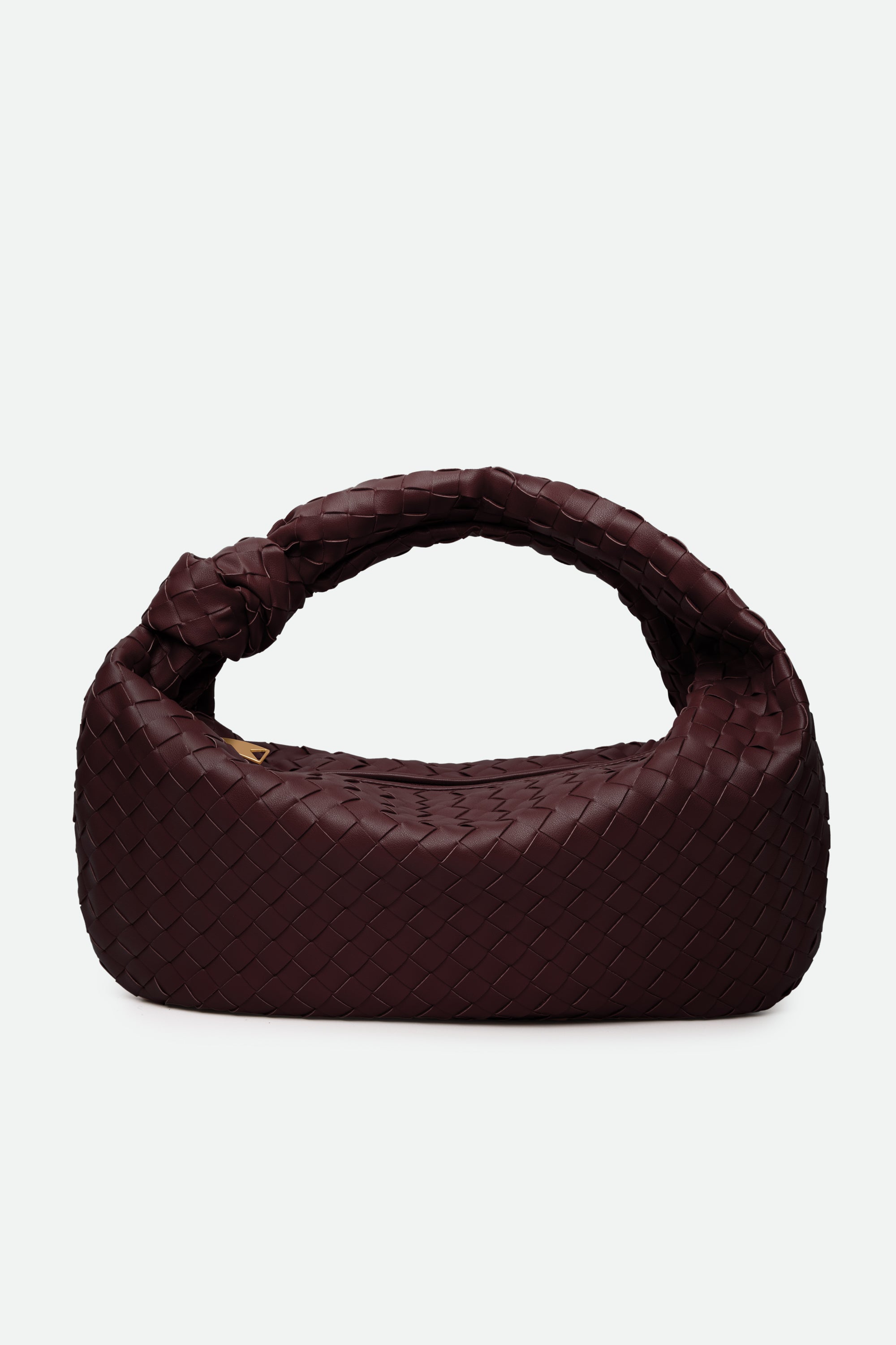 Wine red woven handbag with a knotted handle on a white background