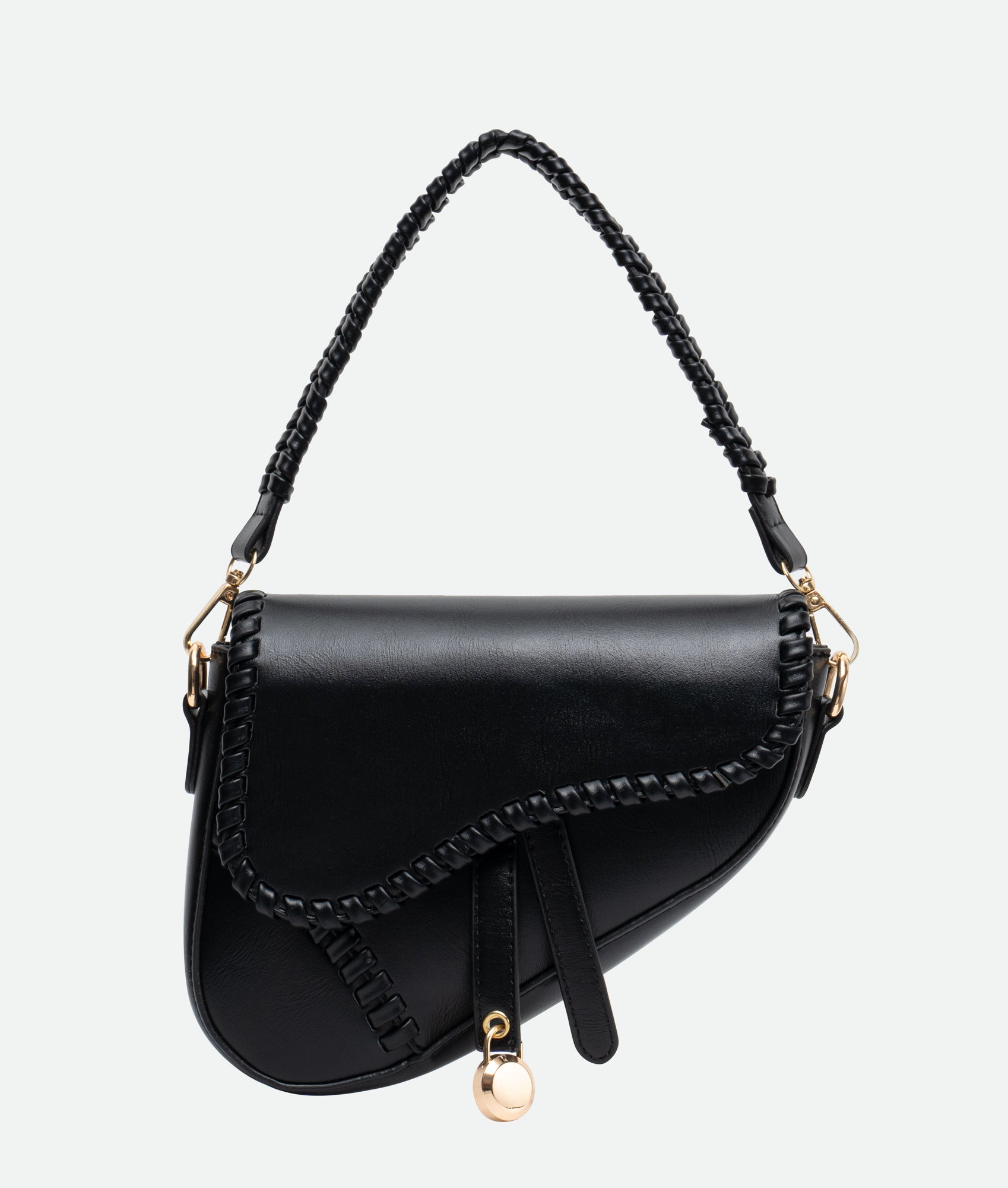 A black saddle bag with gold accents and a braided handle, crafted from vegan leather, featuring intricate stitching.