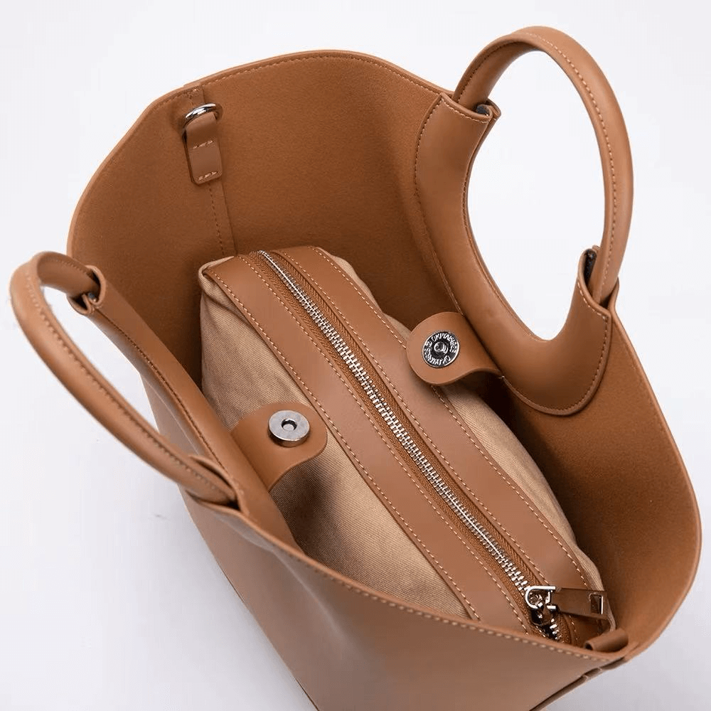 Brown handbag with a visible brand logo on a white background