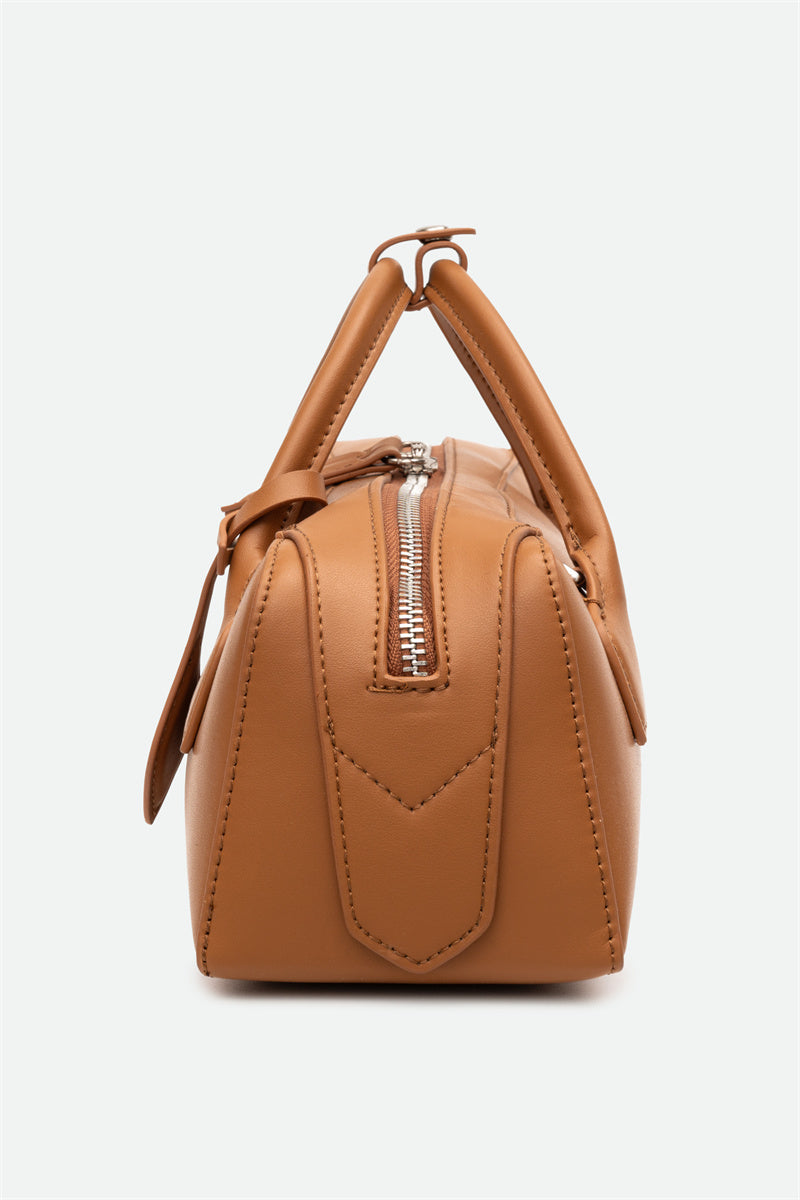 Brown handbag with a zipper on a white background