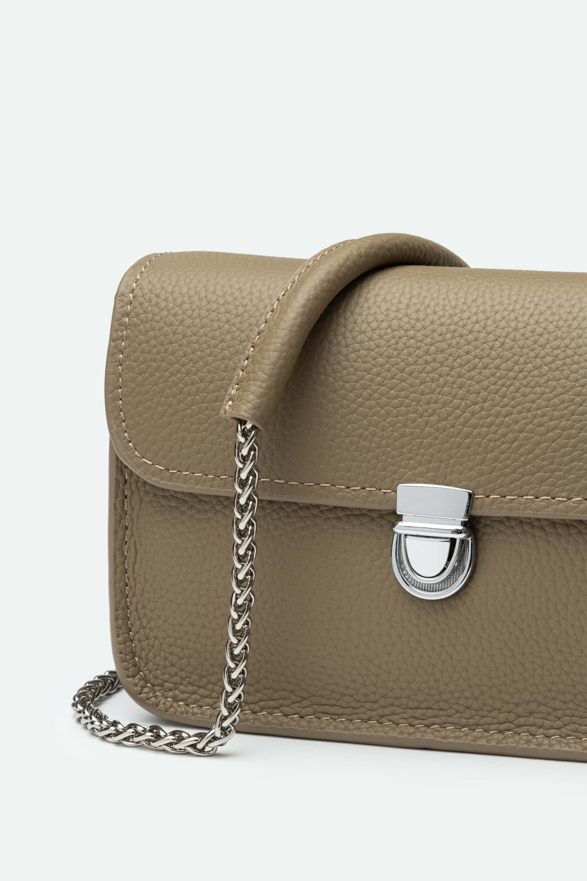 Brown leather handbag with a chain strap on a light gray background