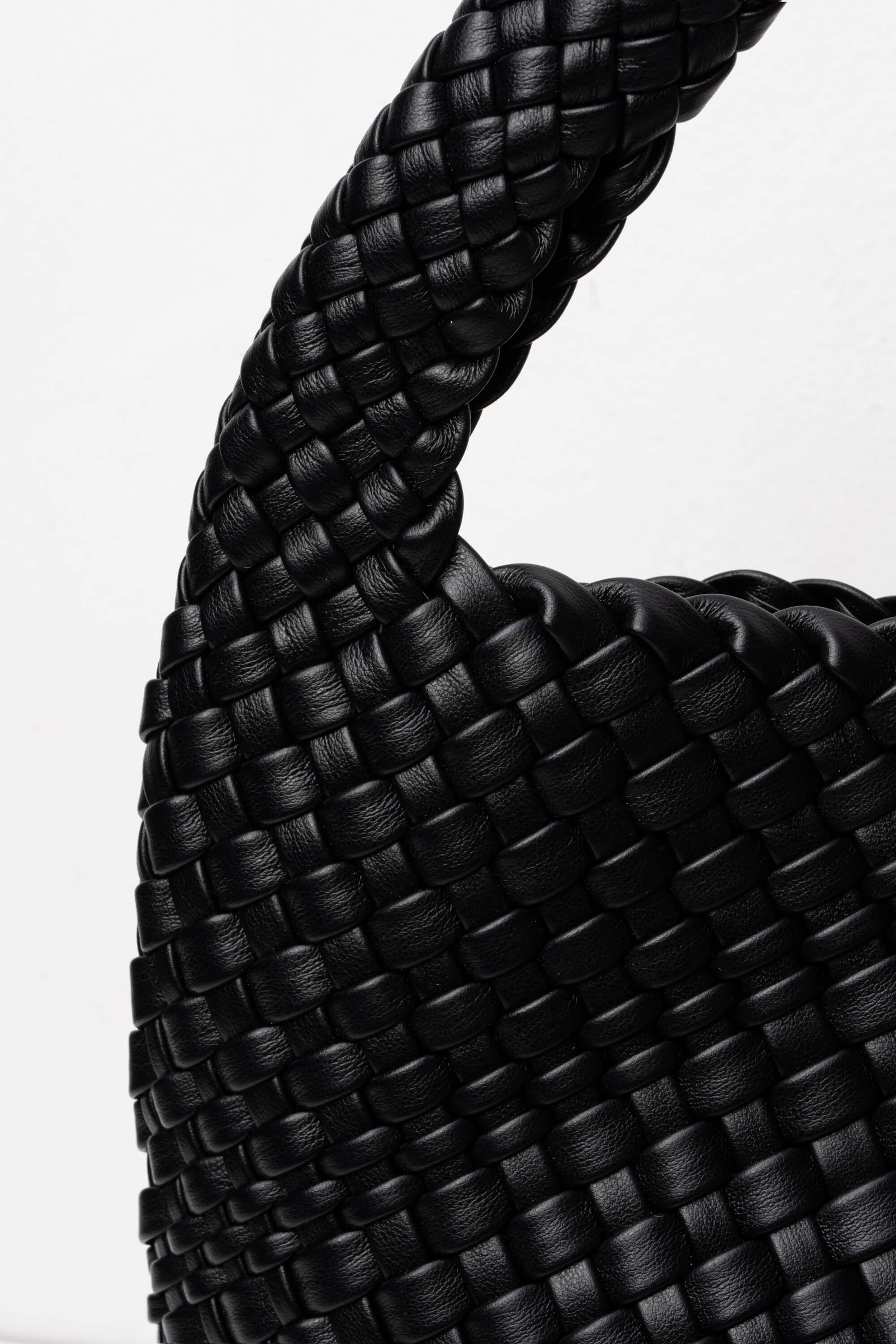 Close-up of a black braided rope on a white background