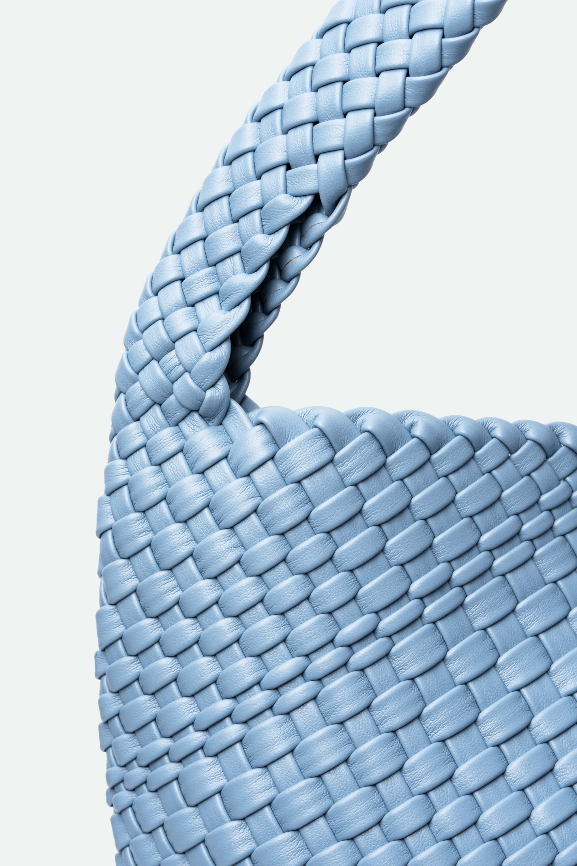 Close-up of a blue woven basket on a light gray background