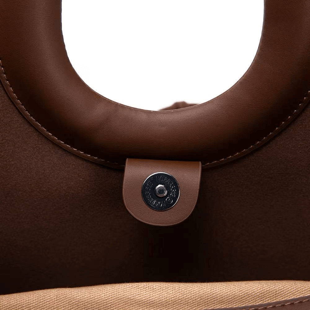Close-up of a brown handbag handle with a metal clasp on a white background