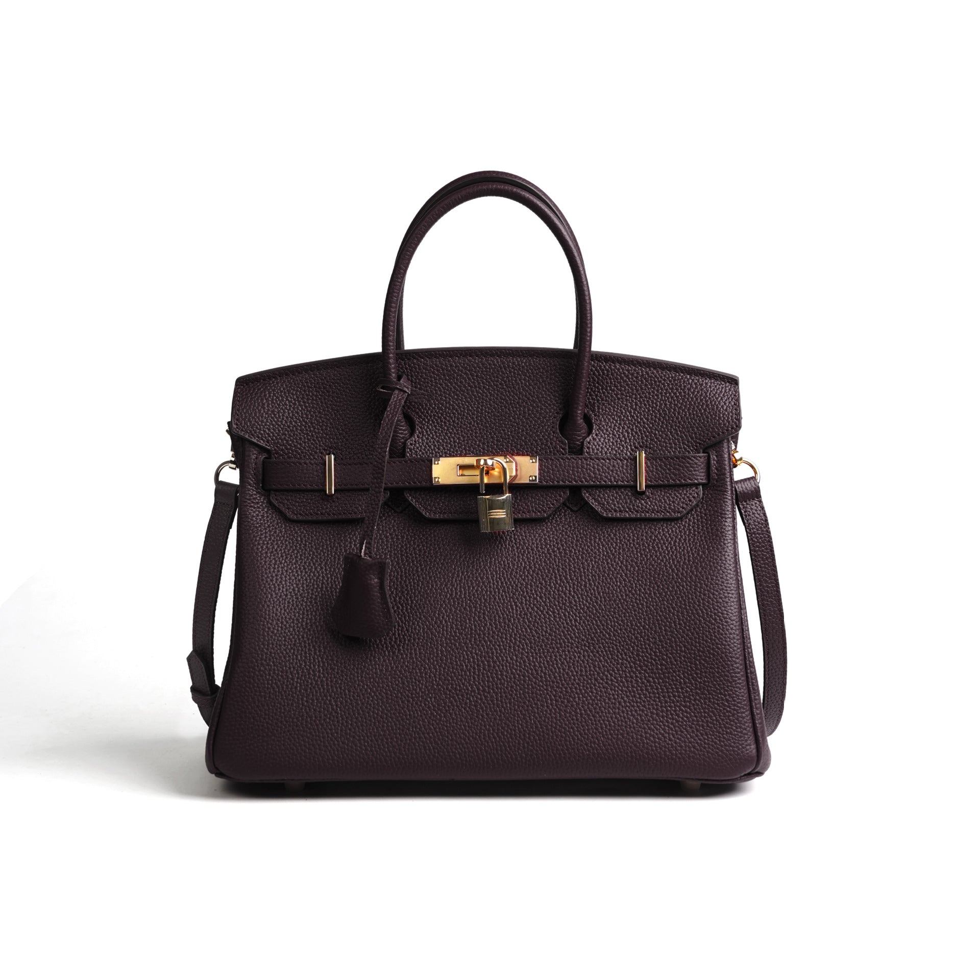 Dark purple handbag with gold hardware on a white background