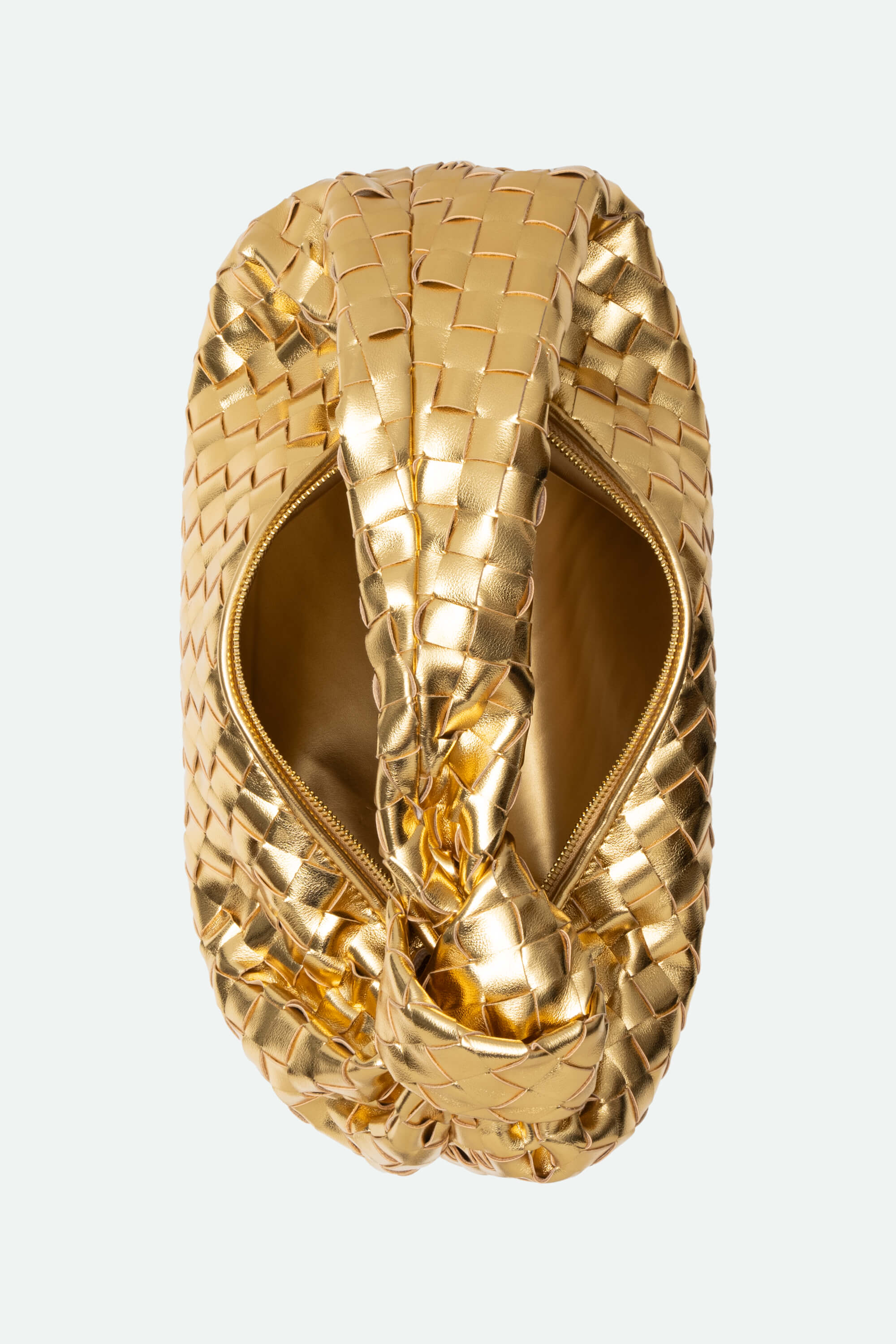 Gold woven ring on a light gray background