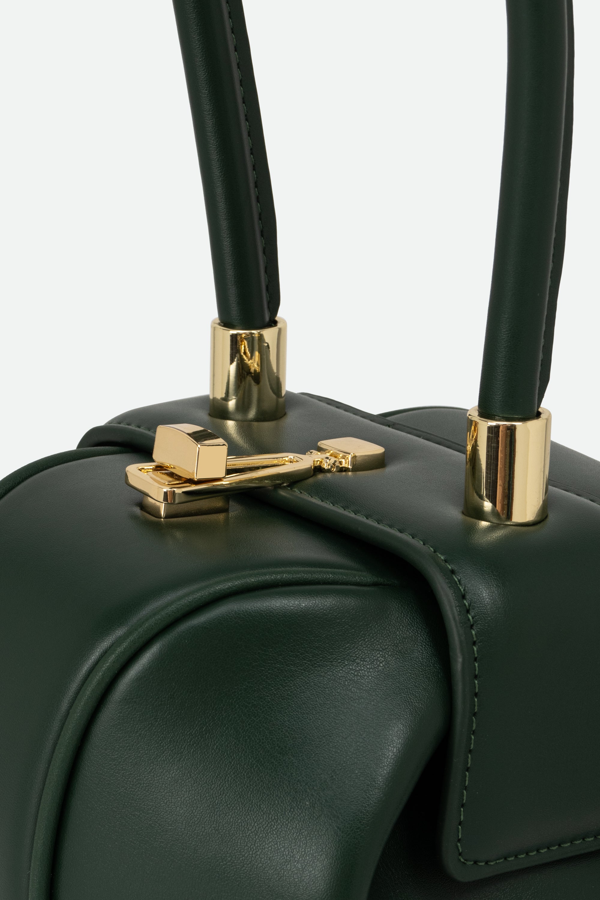 Green handbag with gold hardware on a white background