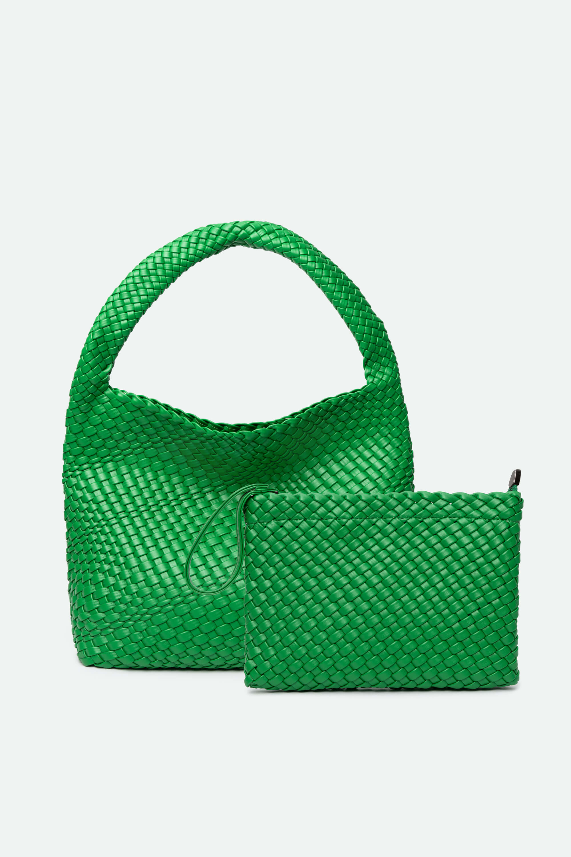 Green woven handbag with matching pouch on a light gray background