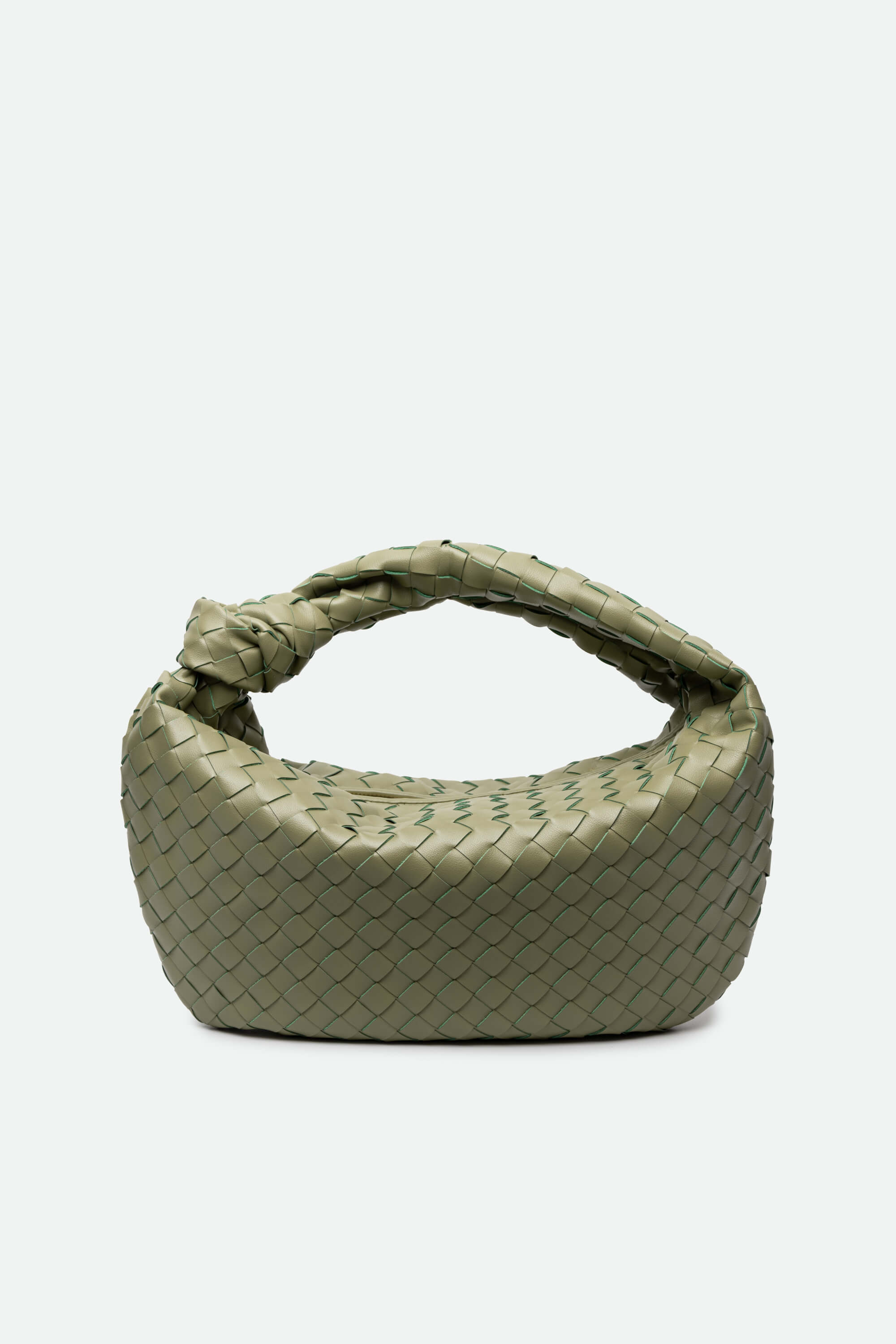 Green woven handbag on a white background
