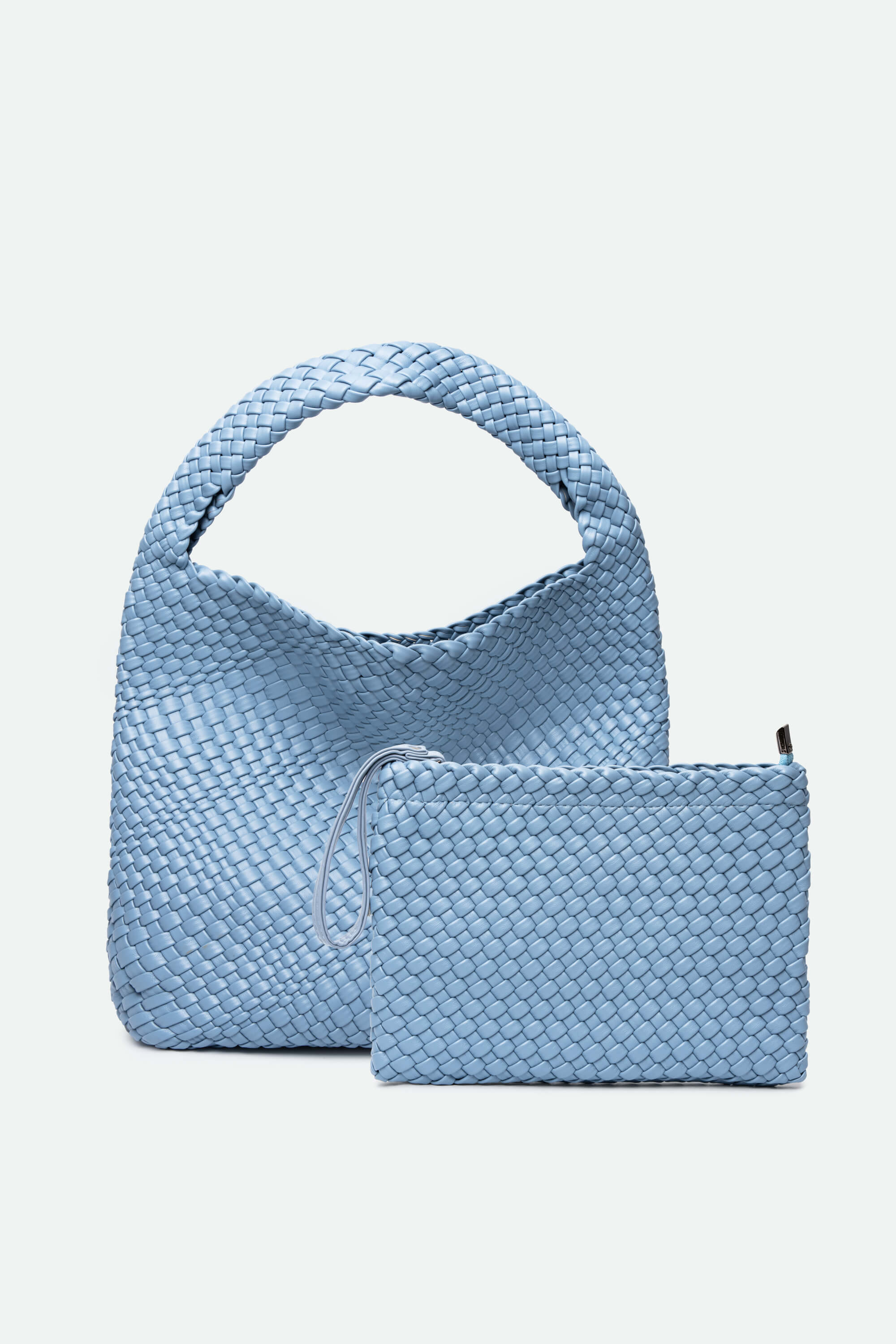 Light blue woven handbag with matching pouch on a light gray background