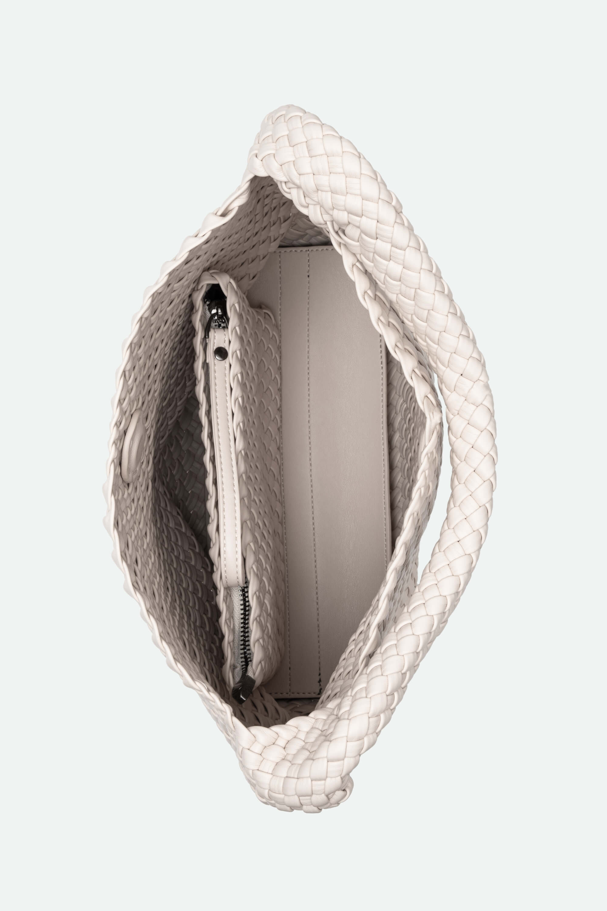 White textured handbag with a visible zipper on a light gray background