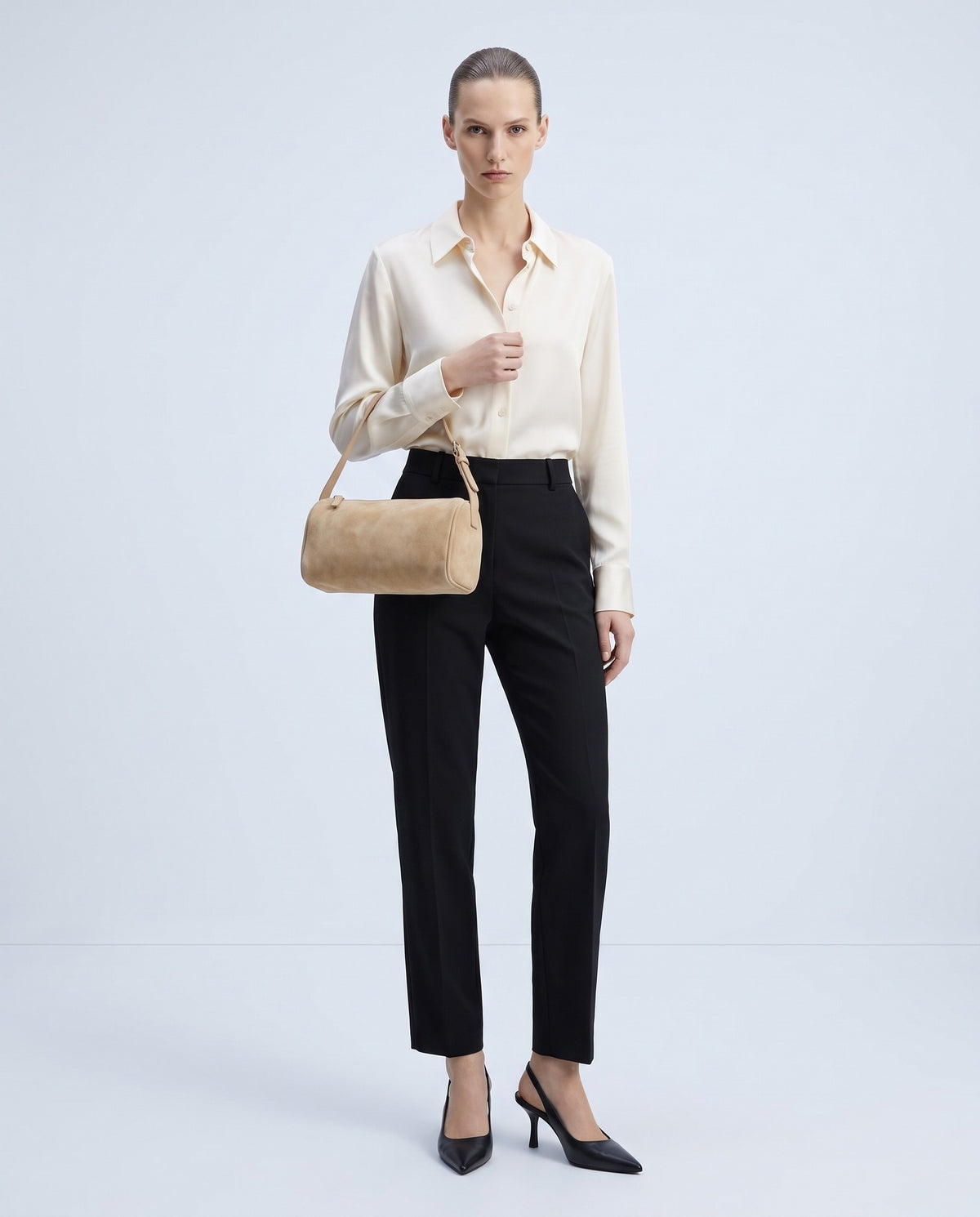 Model wearing the Alba barrel shoulder bag in Beige suede – full length