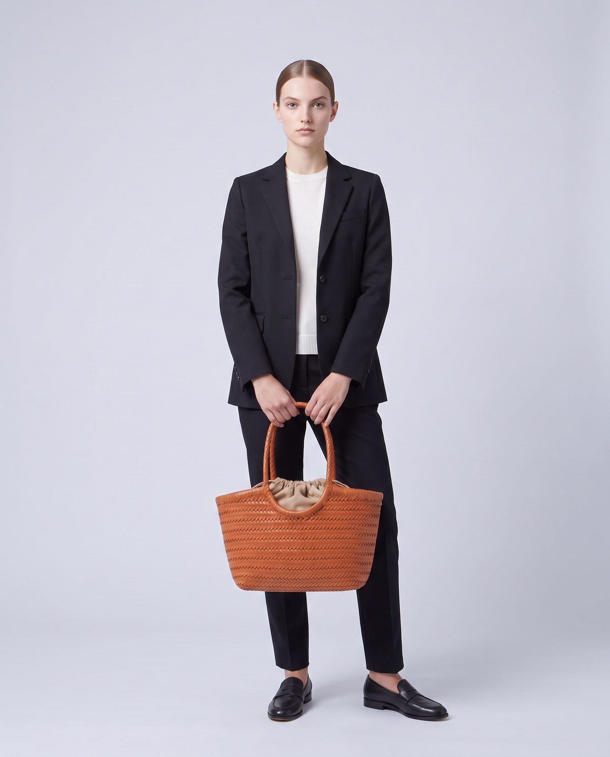 Model carrying the Alghero woven leather tote in Cognac – full length