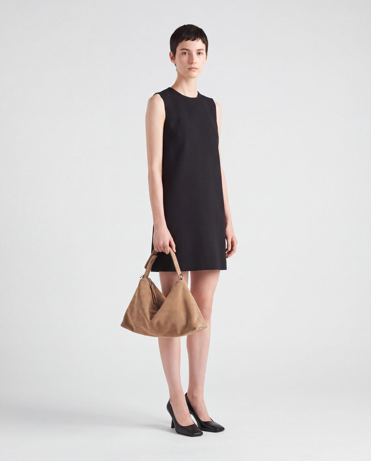 Calma bag in Beige – worn by model, full length