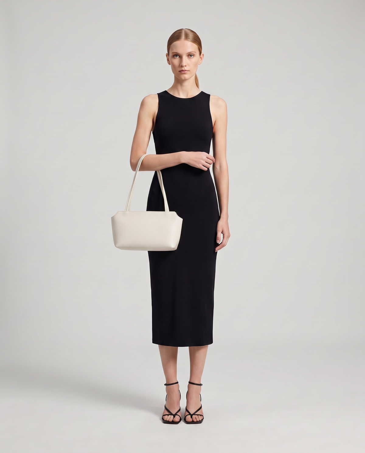 Model with the Capri leather shoulder bag in white, full length