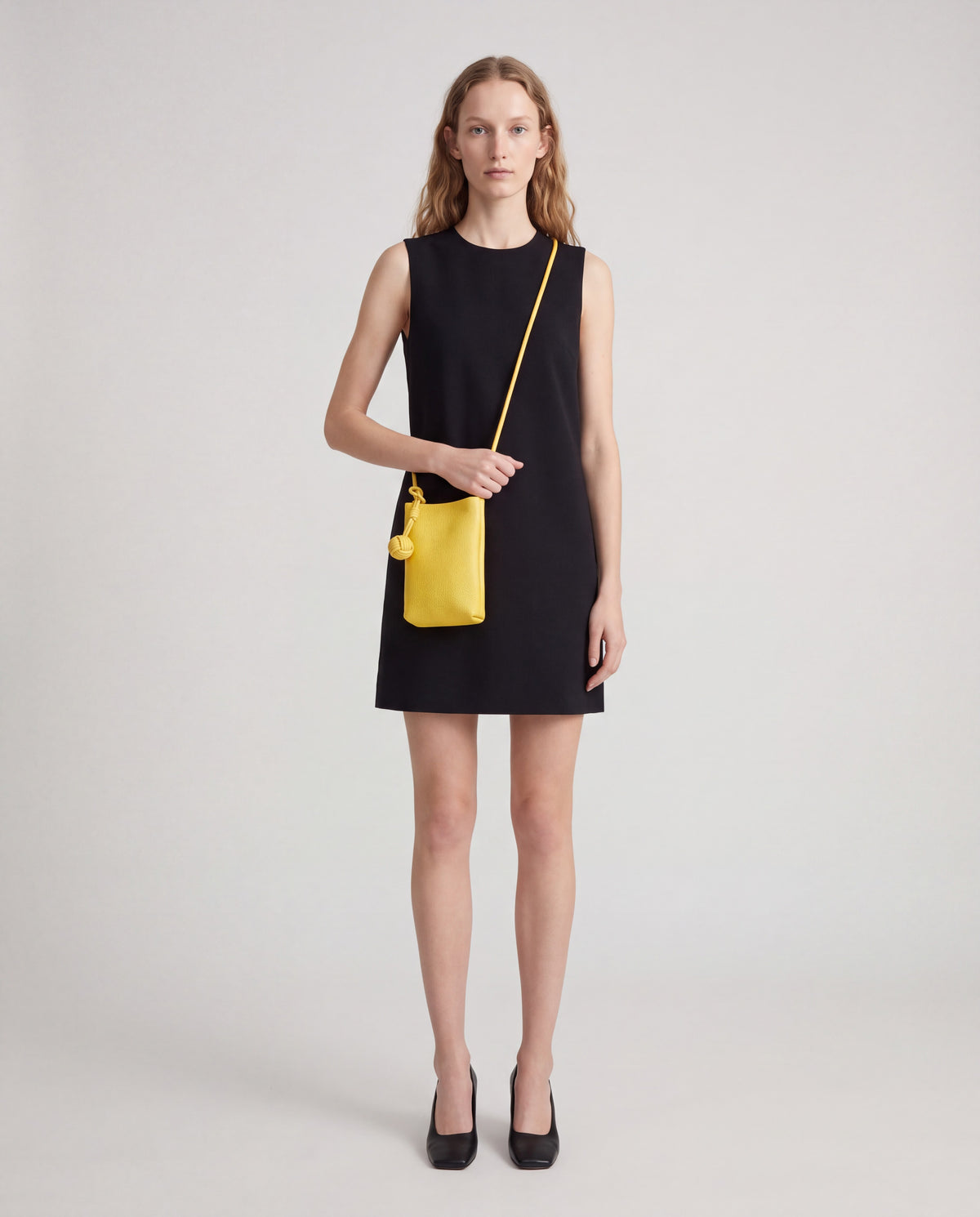 Cara bag in Yellow – worn by model, full length