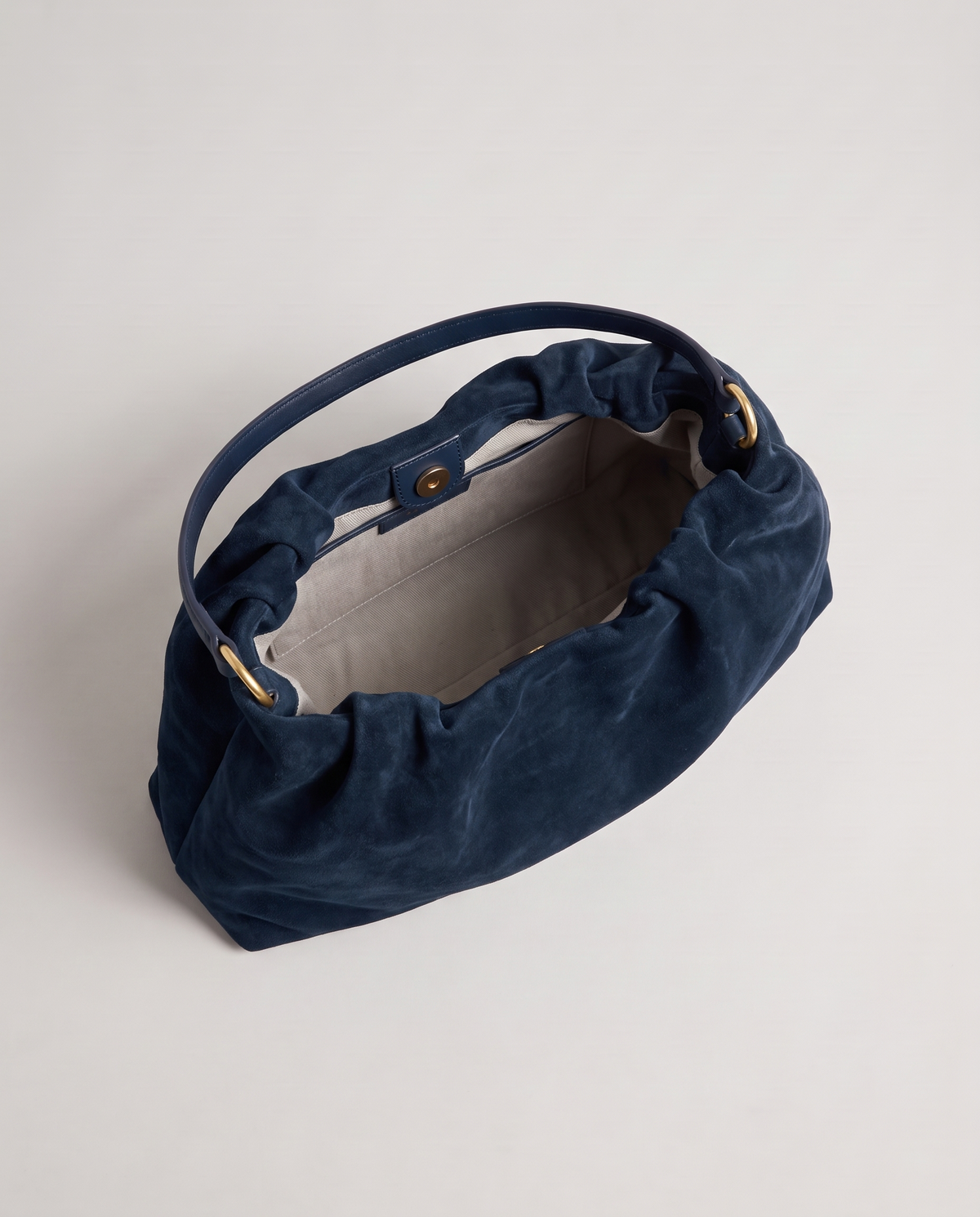 Cielo gathered suede bag in navy, open showing interior