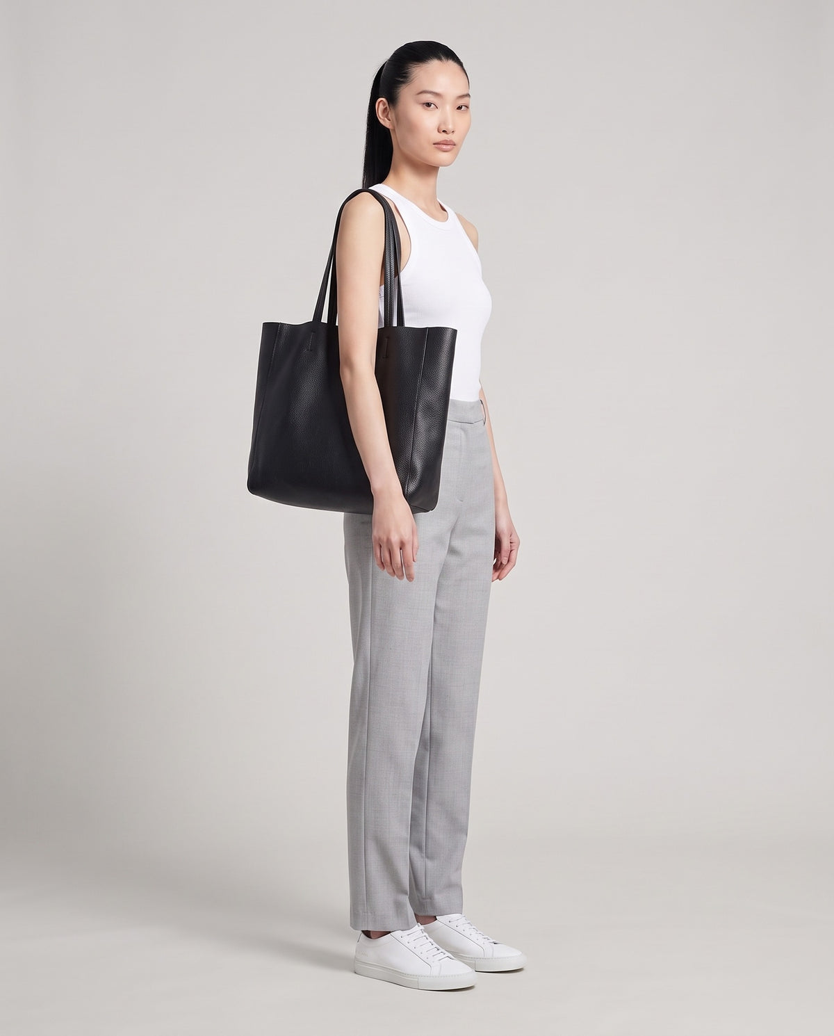 Model with the Costa leather tote in black, full length
