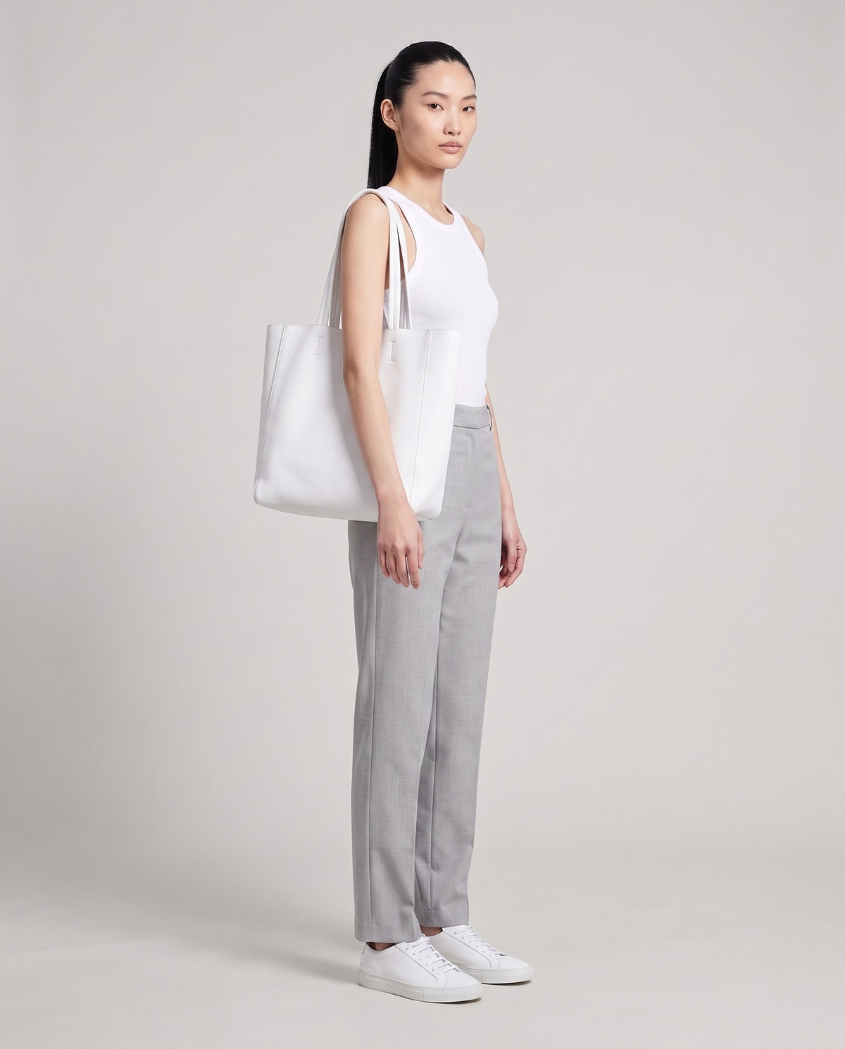 Model with the Costa leather tote in white, full length