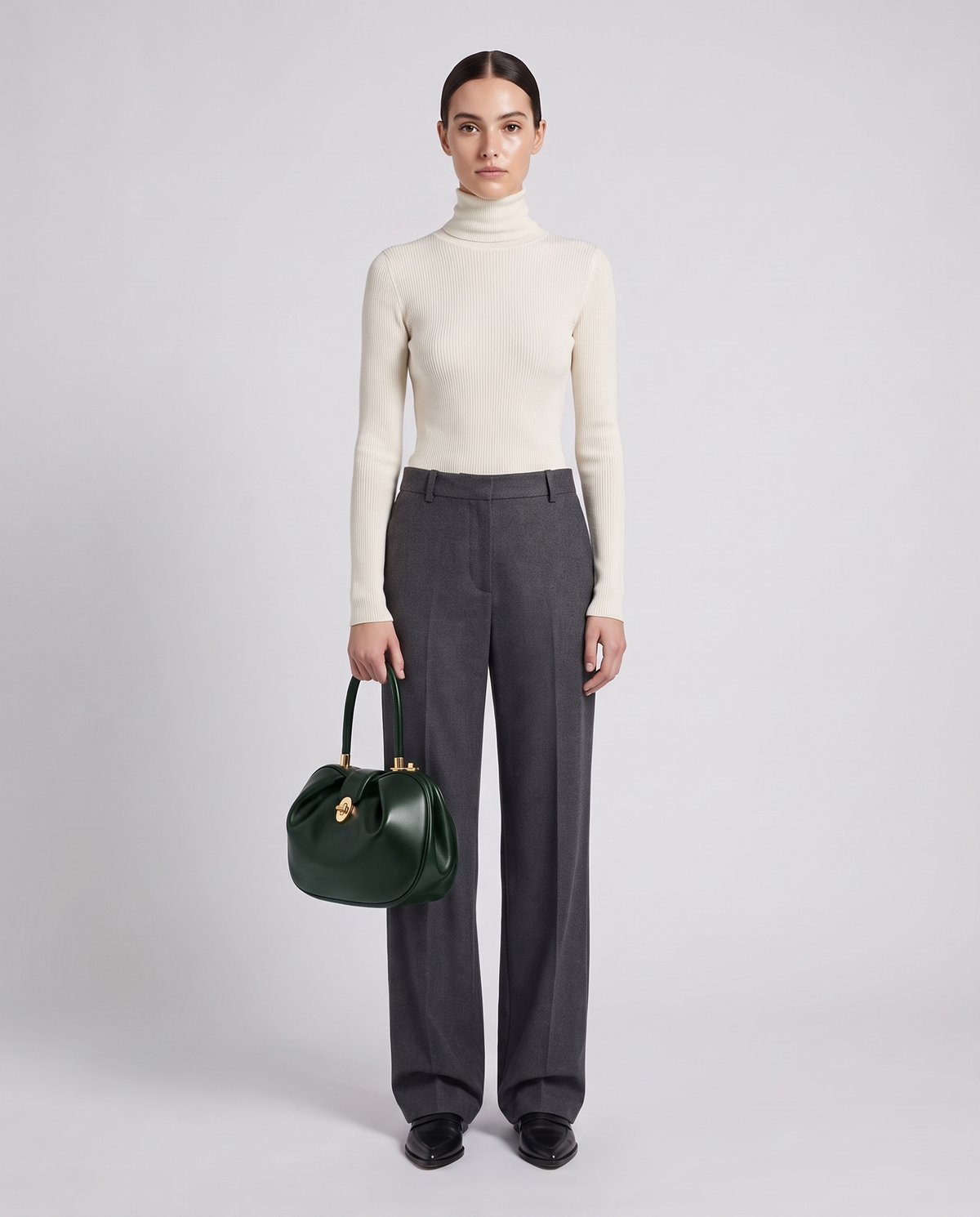 Dumpling Maxi leather top-handle bag in Green – model holding it, full length