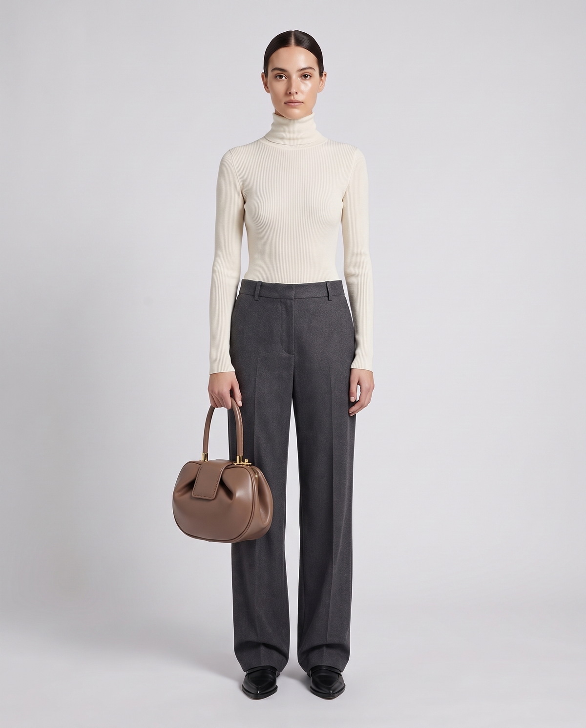 Dumpling Maxi leather top-handle bag in Nude – model holding it, full length