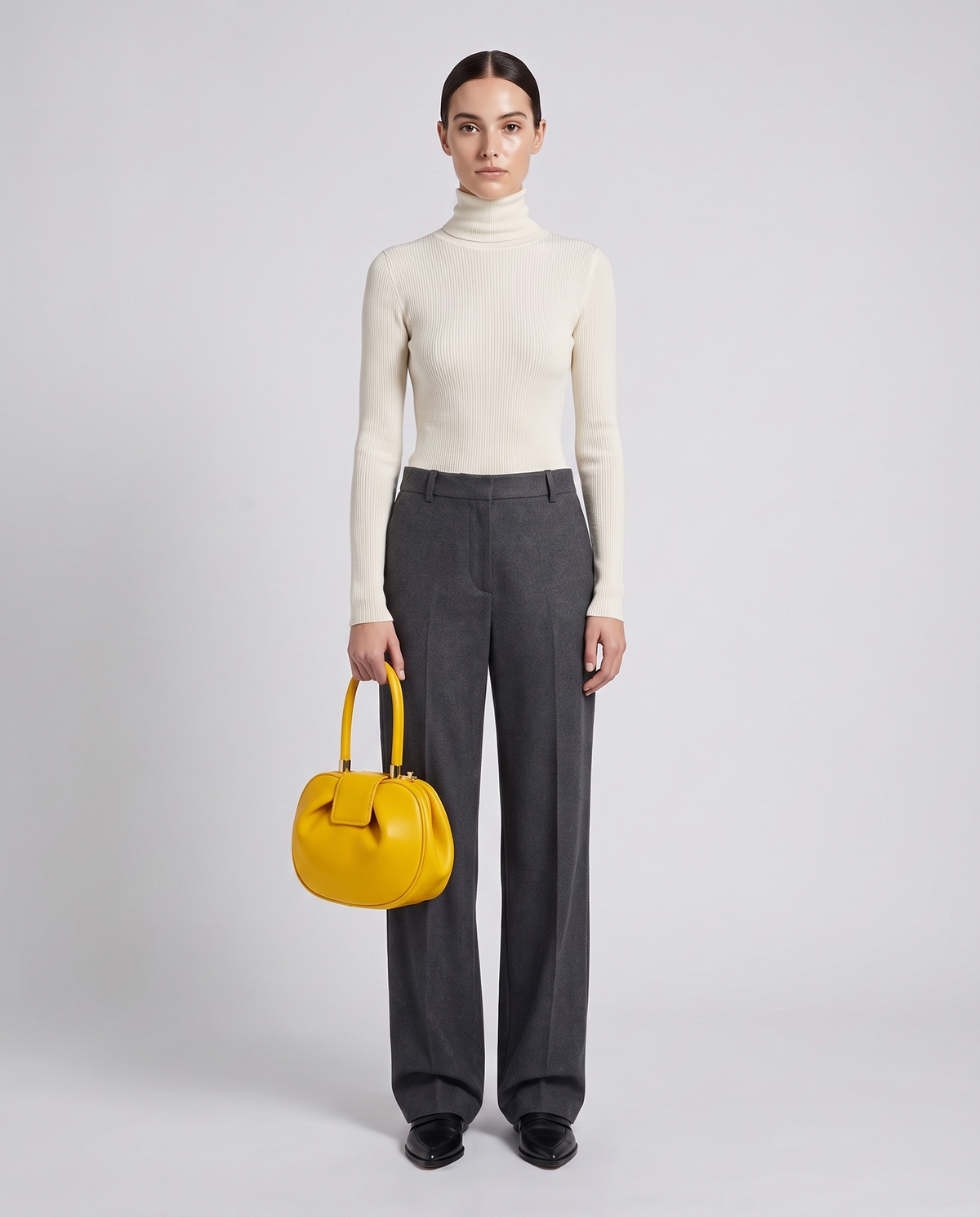 Dumpling Maxi leather top-handle bag in Yellow – model holding it, full length
