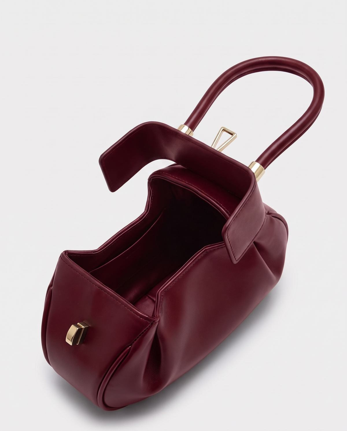Dumpling Mini leather top-handle bag in Red – open, showing the leather-lined interior